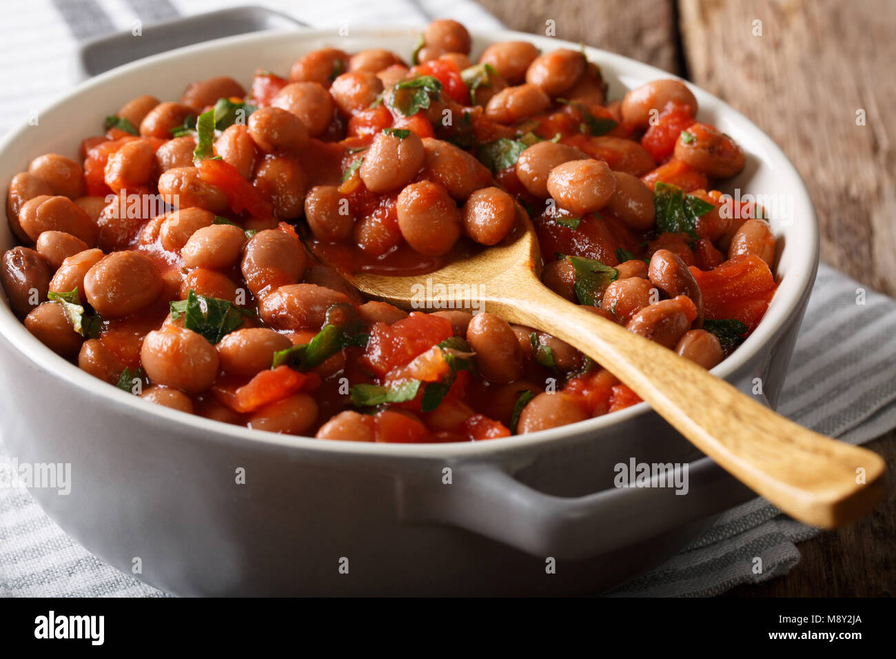 Healthy Food Stew Borlotti Beans In Tomato Sauce With Herbs Close Up In A Bowl On The Table