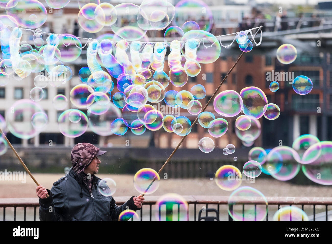 Bubbles created by a man on the South Bank in London. Stock Photo