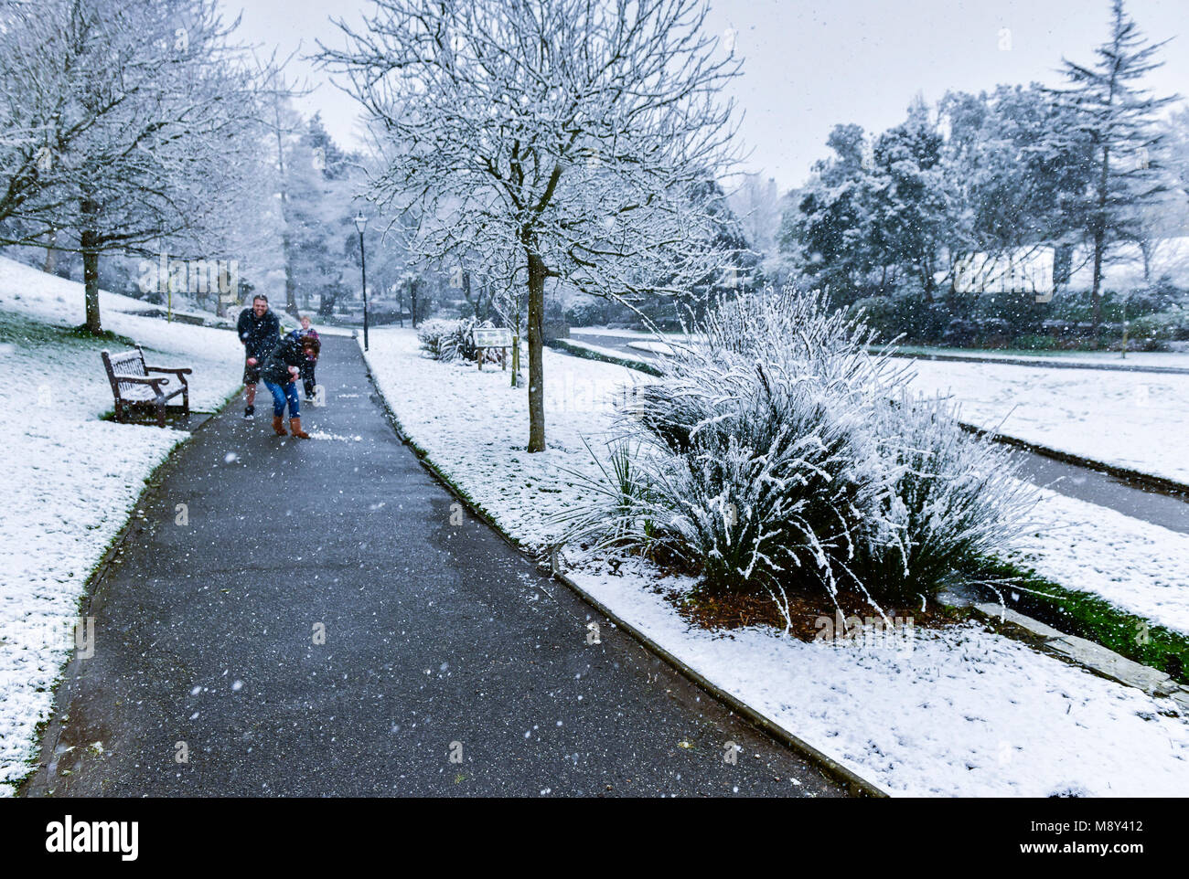 A family enjoying the snow in Trenance Gardens in Newquay Cornwall
