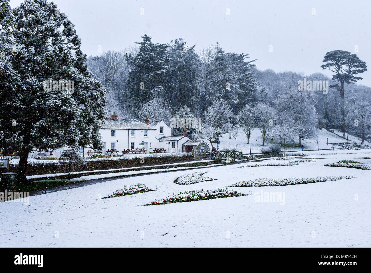 Snow falling over the historic Trenance Heritage Cottages in Newquay Cornwall. Stock Photo