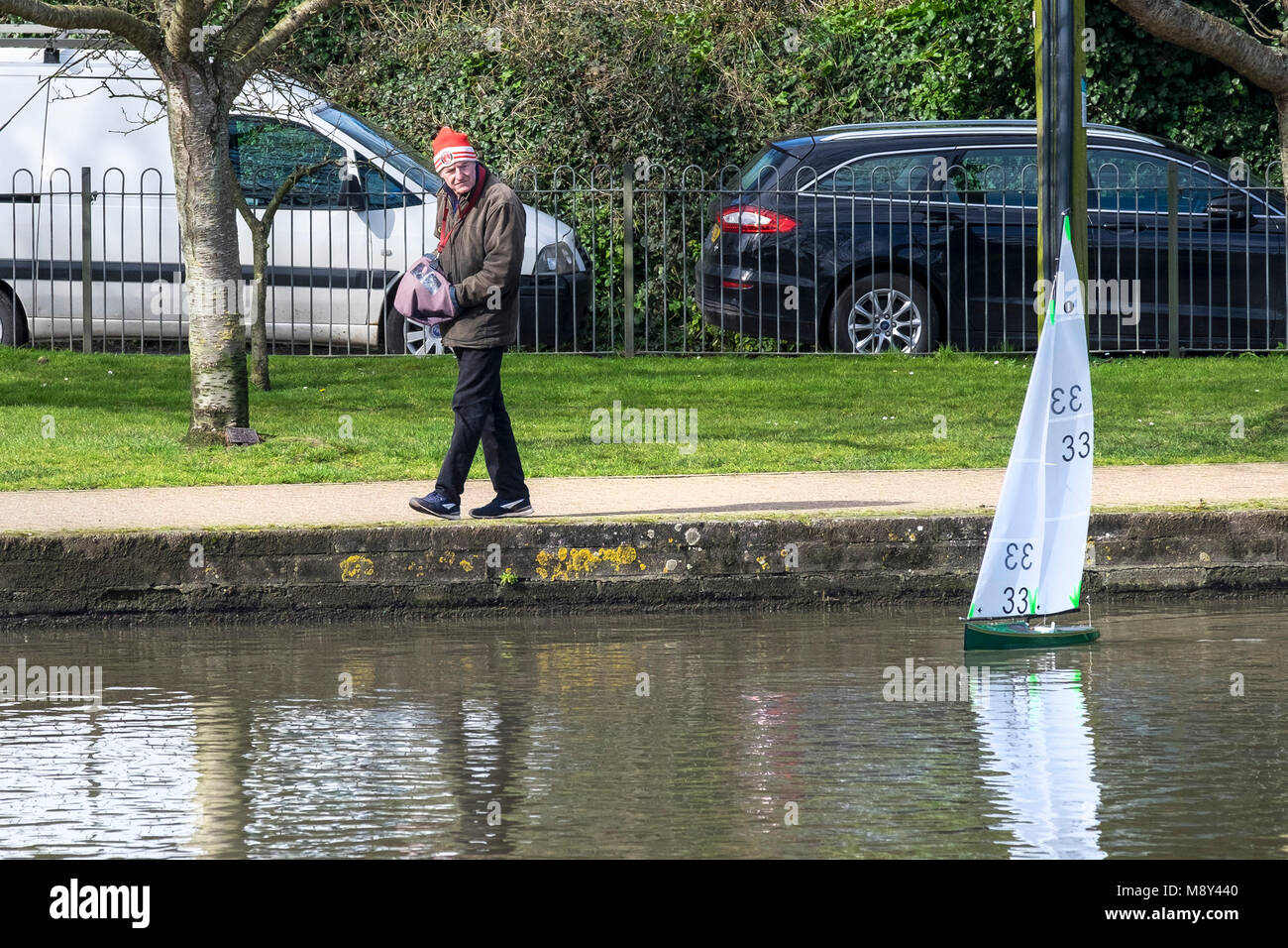 A member of the Newquay Model Yacht Club at Trenance Boating Lake controlling his model racing yacht Newquay Cornwall. Stock Photo