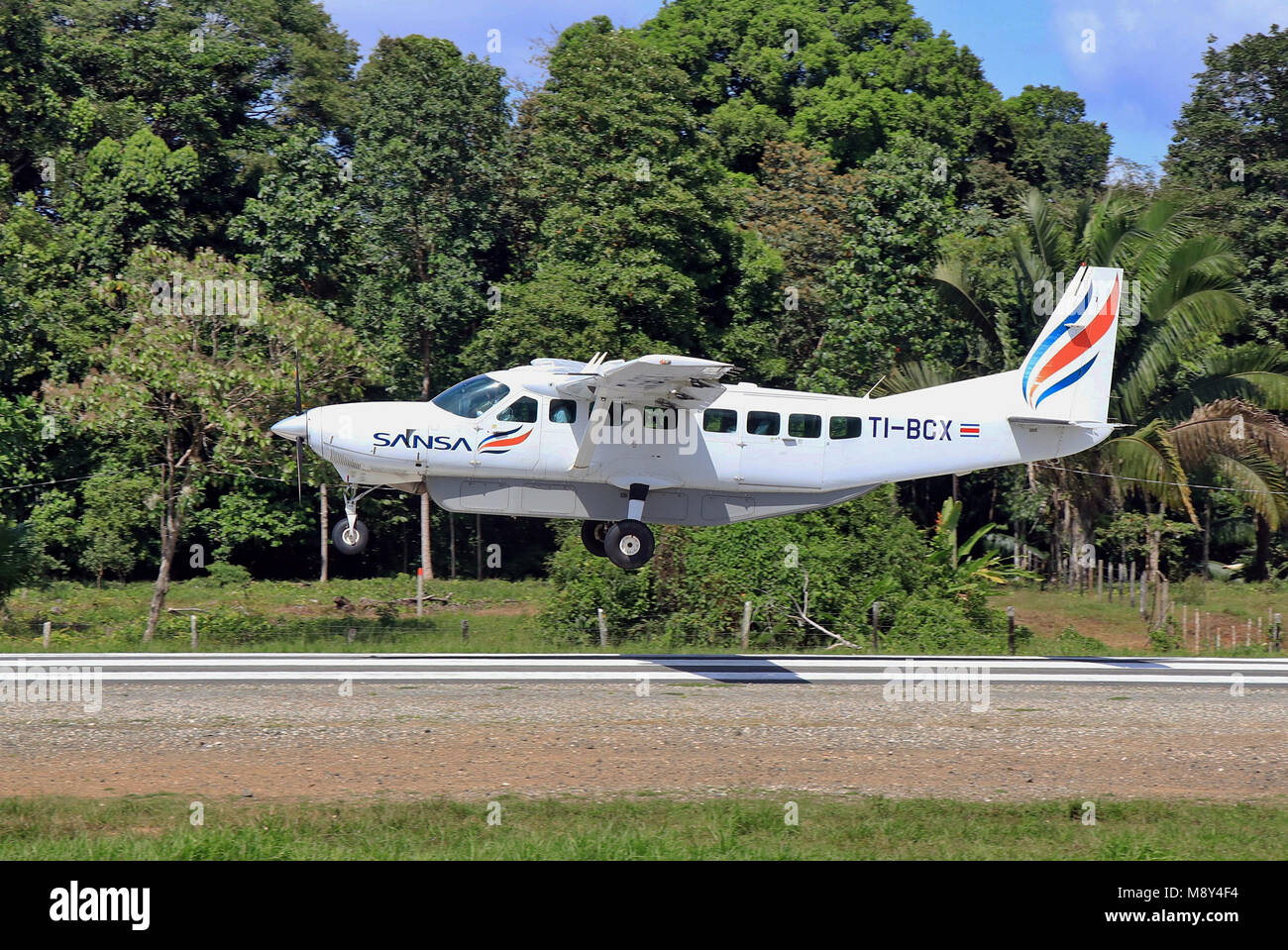 SANSA Cessna 208 Regional flight landing at the remote Drake Bay airstrip in the jungles of the Osa Peninsula in Southern Costa Rica. Stock Photo