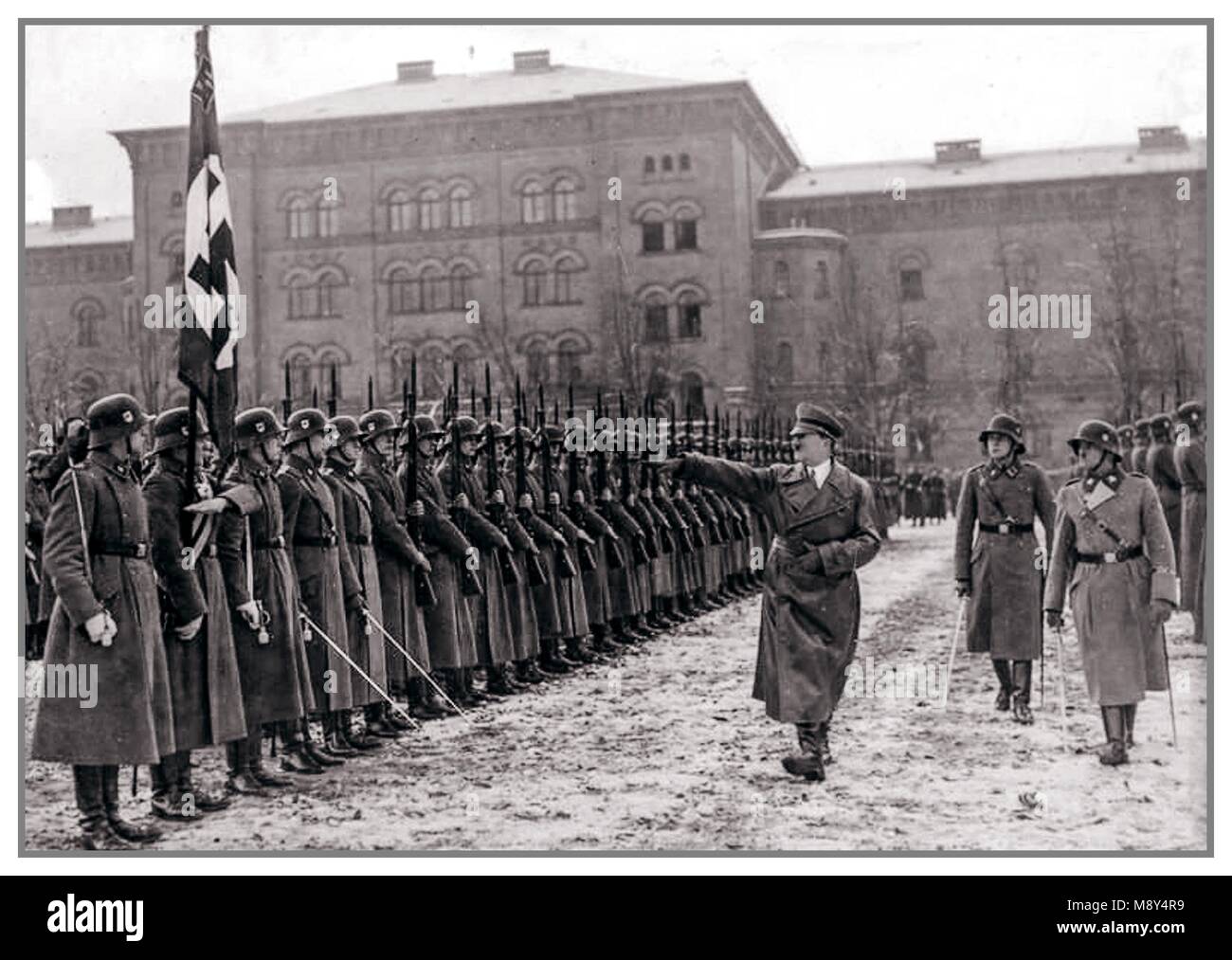 ADOLF HITLER TAKING SALUTE FROM LEIBSTANDARTE PARADE Vintage pre-WW2 black and white photo of men of Leibstandarte 'Adolf Hitler' WAFFEN SS troops at the Lichterfelde barracks in Berlin, Germany, November 22, 1938. Stock Photo