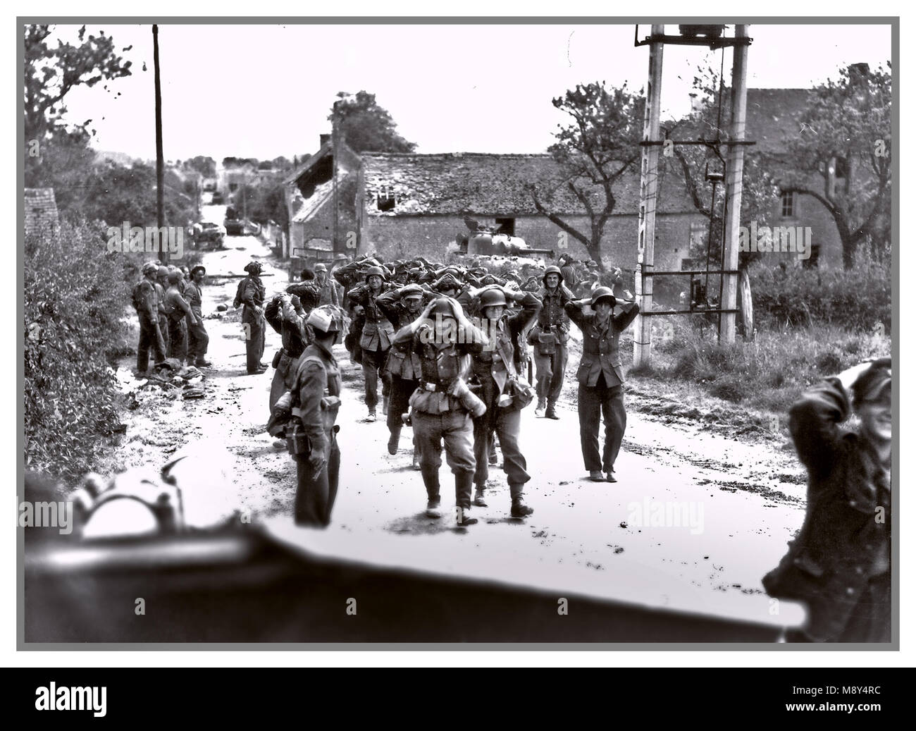 1944 Normandy France German Troops Surrender POW’s WW2 Historic B&W image of Wehrmacht and Waffen SS German troops army forces surrendering with hands up on head, in Saint-Lambert-sur-Dive Normandy France 21 August 1944 The Falaise pocket or battle of the Falaise pocket (German: Kessel von Falaise; 12–21 August 1944) was the decisive engagement of the Battle of Normandy in the Second World War. Allied forces formed a pocket around Falaise, Calvados, in which German Army Group B, consisting of the 7th Army and the Fifth Panzer Army (formerly Panzergruppe West), were encircled by Allies Stock Photo