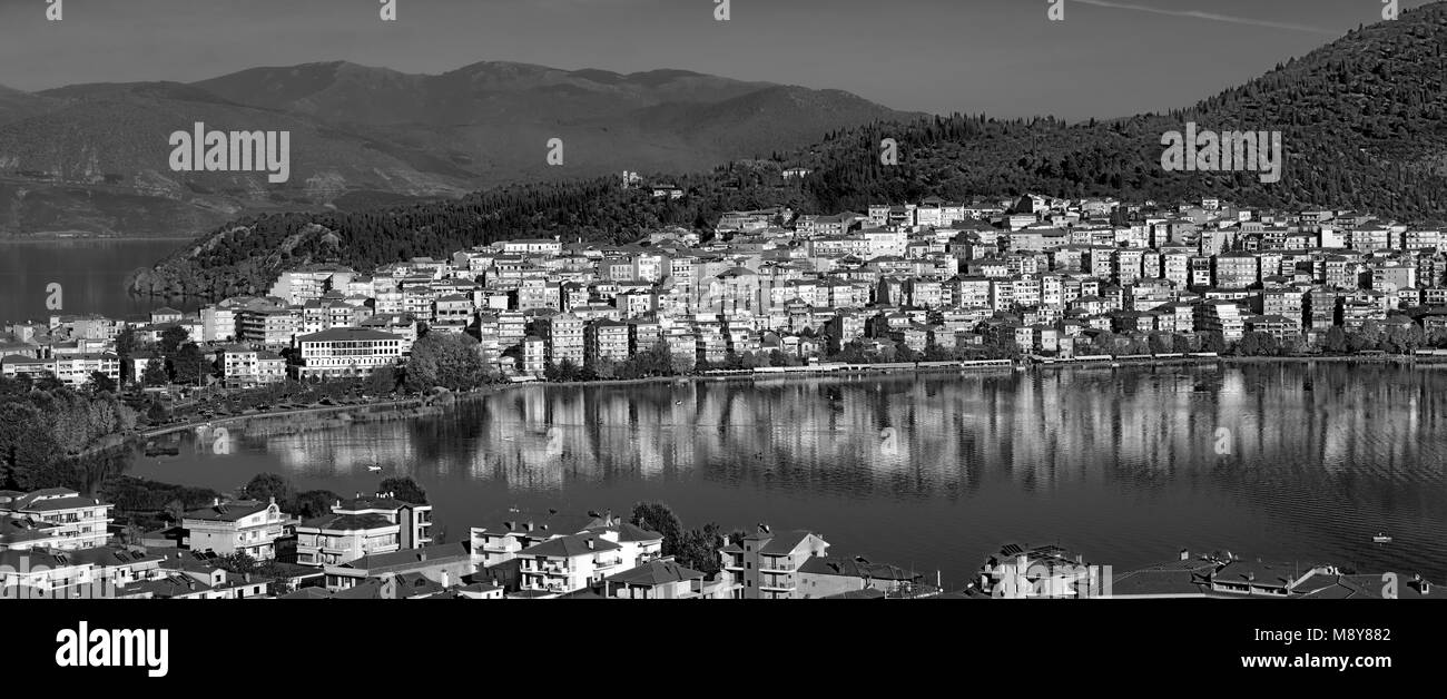 Panoramic view of Kastoria city reflected on the tranquil surface of Orestiada lake, in West Macedonia, Northern Greece Stock Photo