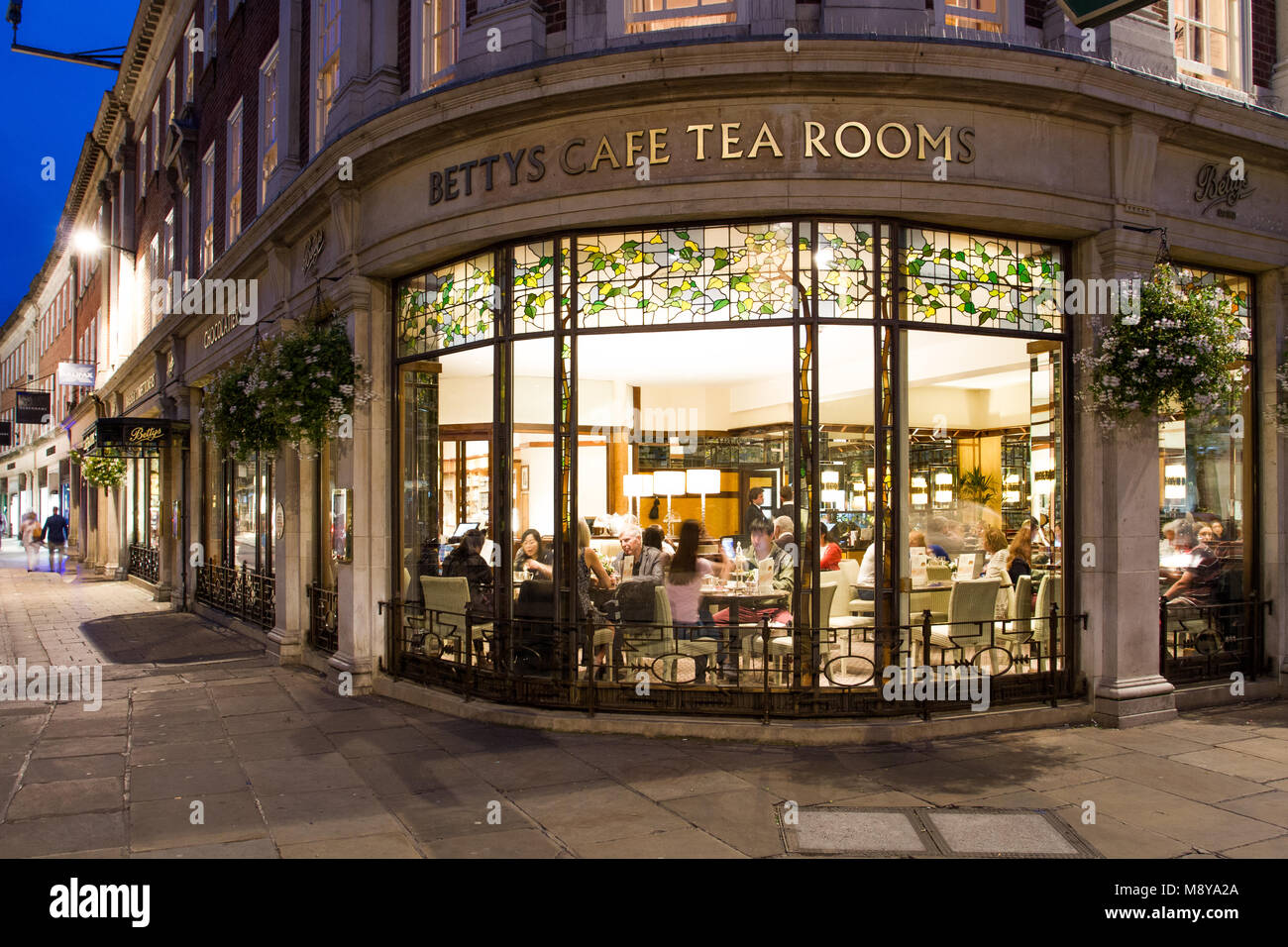 St Helens Square, York, UK - SEPTEMBER 9, 2016. The exterior of the popular Betty's Cafe and Tea Rooms shown at night with a warmly lit interior. Stock Photo