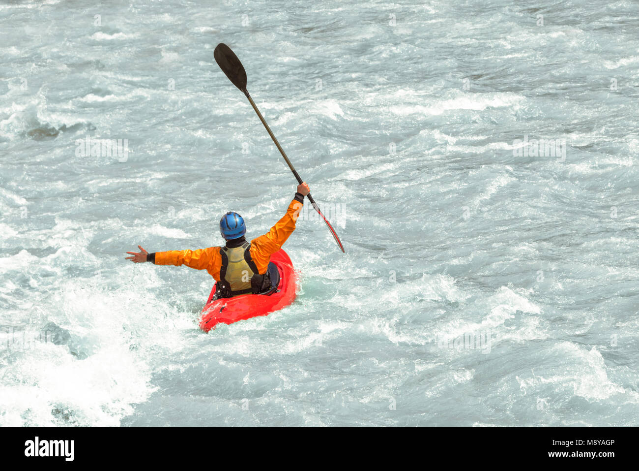 Kayaker having fun in white water rapids,  with copy space Stock Photo