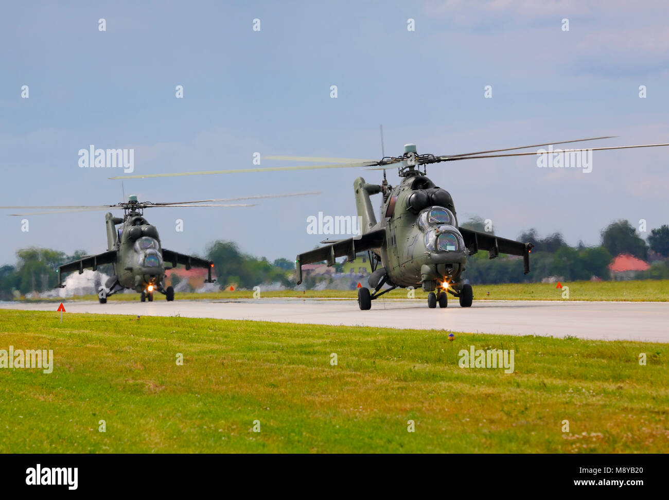 Pair of the Polish Air Force Mil Mi-24D Hind-D on runway during International Air Show at the 90th Jubilee of The Polish Air Force Academy. Stock Photo