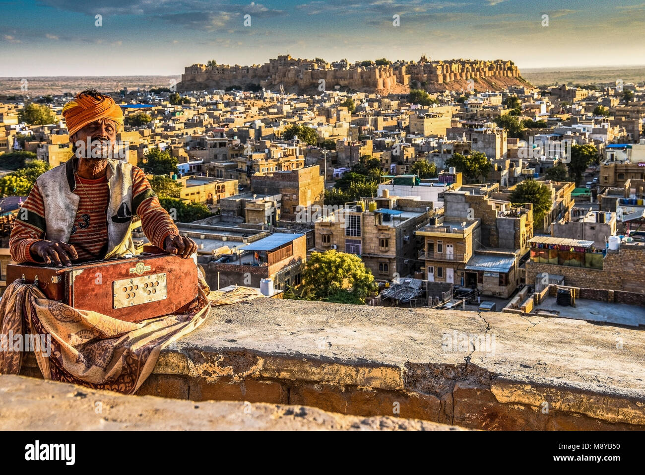 INDIA RAJASTHAN Jaisalmer Harmonium player at sunset point with the