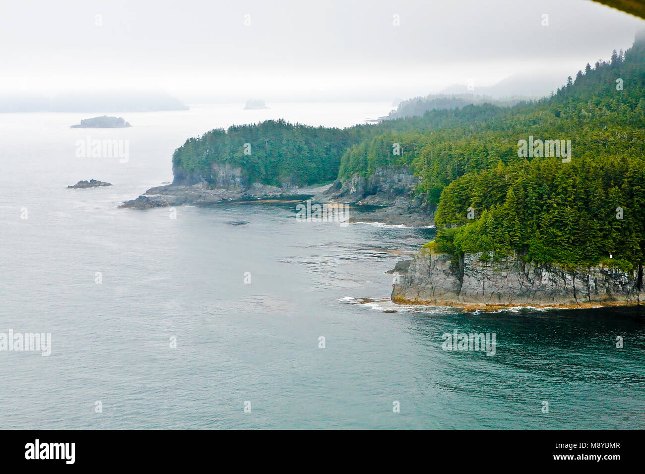 Aerial view of uninhabited areas of Alaska's forested coastline and
