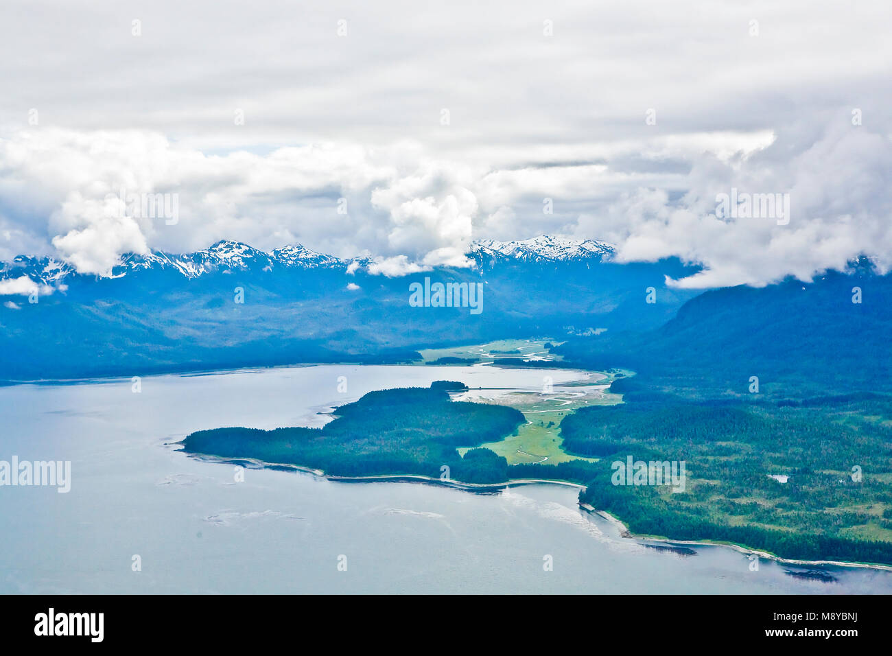 Aerial view of uninhabited areas of Alaska's forested coastline and