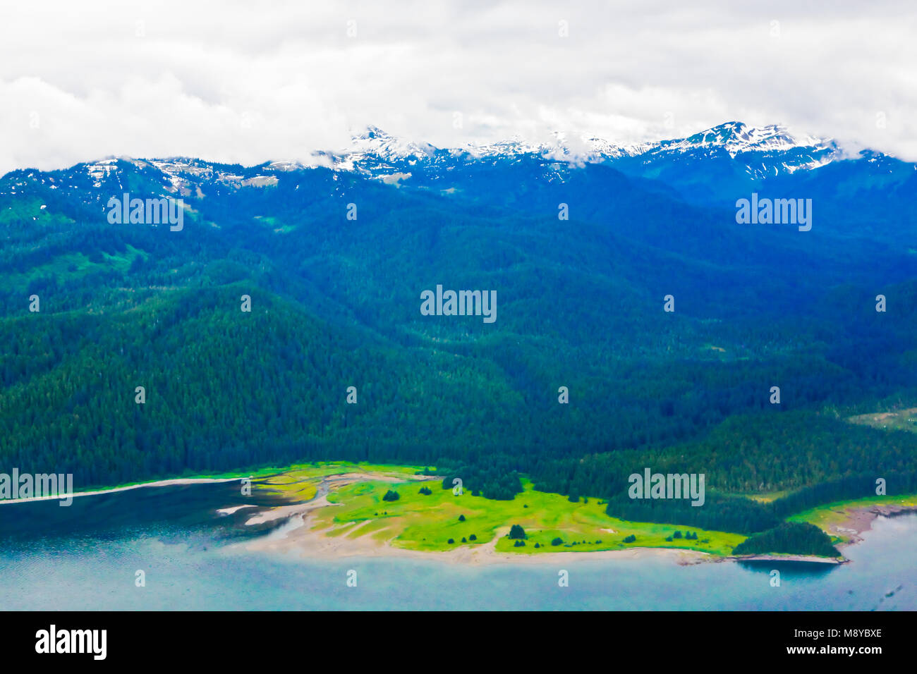 Aerial view of uninhabited areas of Alaska's forested coastline and