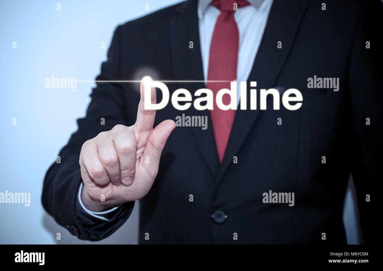 Businessman pressing on virtual screen and selecting deadline Stock Photo