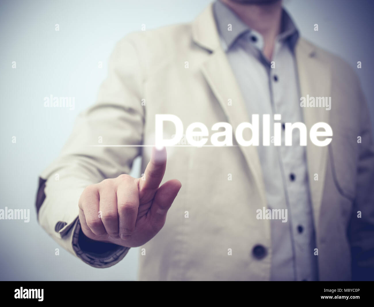 Businessman pressing on virtual screen and selecting deadline Stock Photo