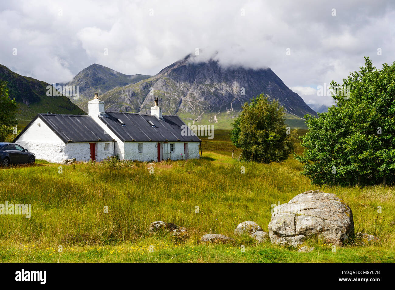 Blackrock Cottage with Buachaille Etive More in the background - Rannoch Moor, at entrance to Glen Coe, Highland Region, Scotland, UK Stock Photo
