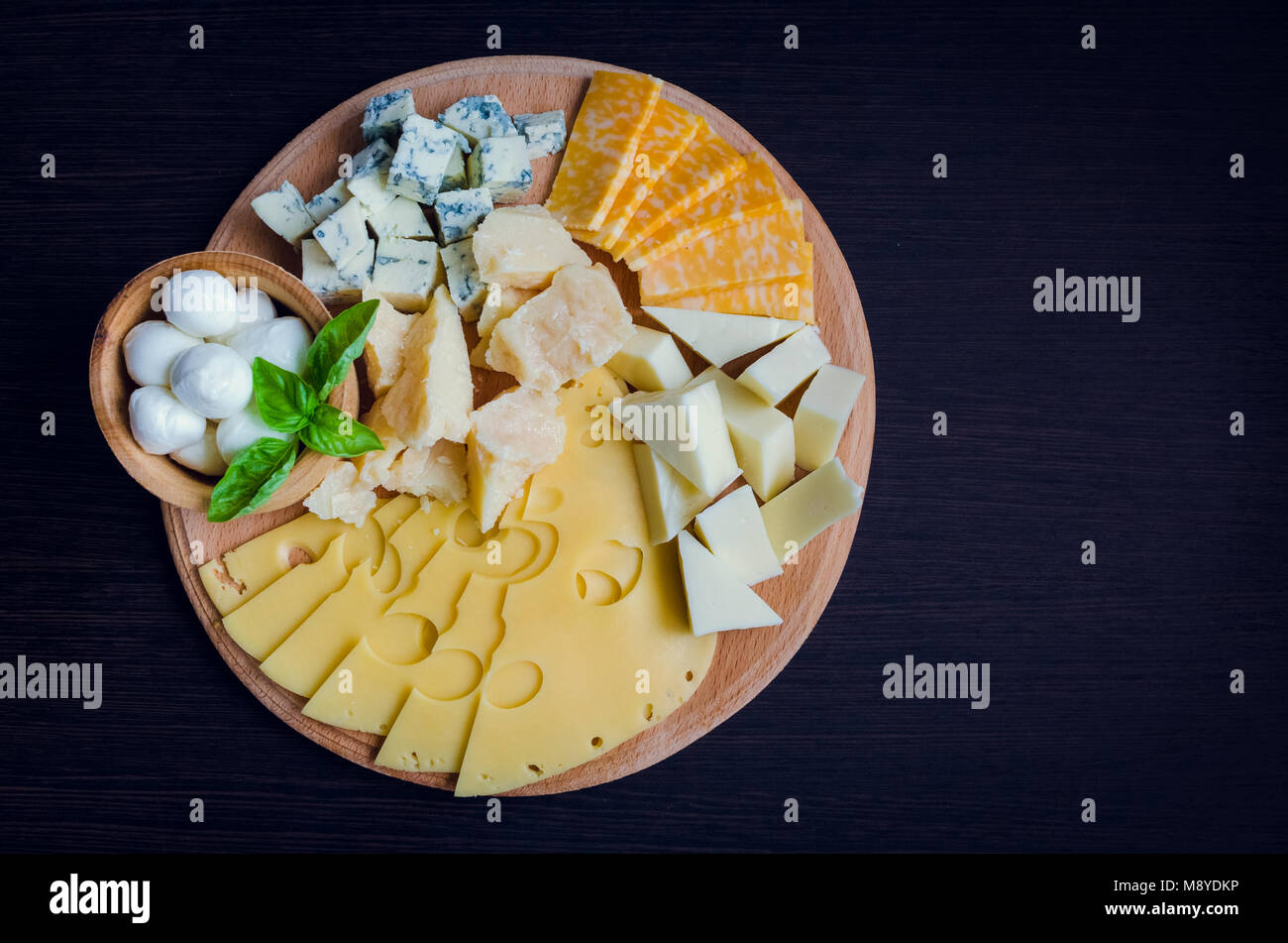 Cheese plate: Parmesan, cheddar, gouda, mozzarella and other with basil ...