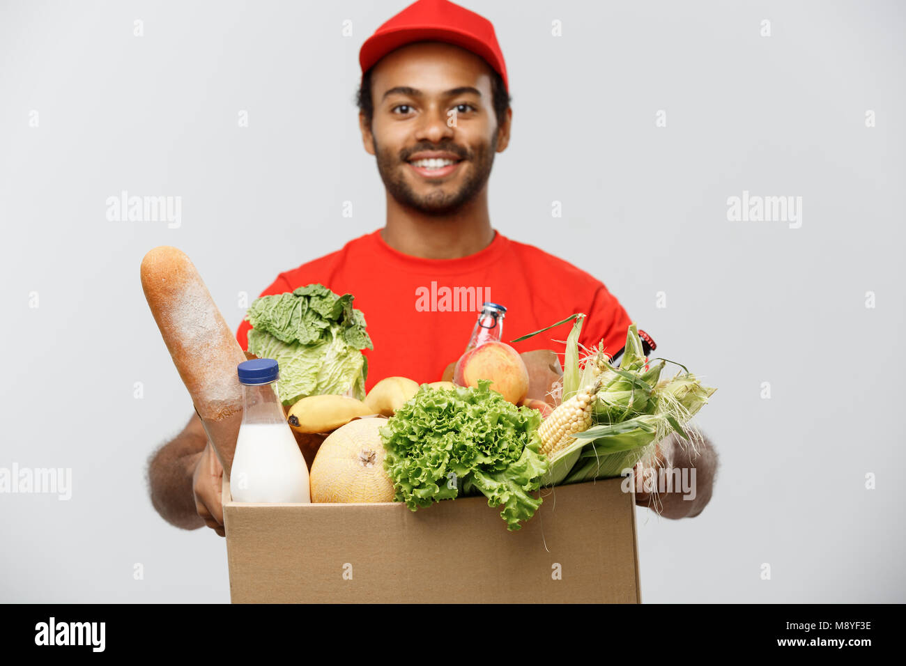 Delivery Concept Handsome African American delivery man carrying