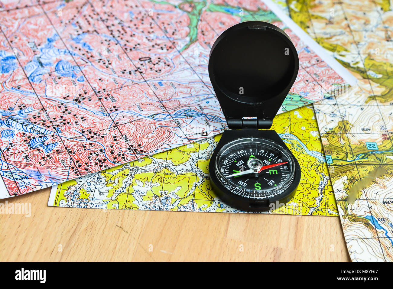 Maps and compass. Planning a trip, laying a route Stock Photo Alamy