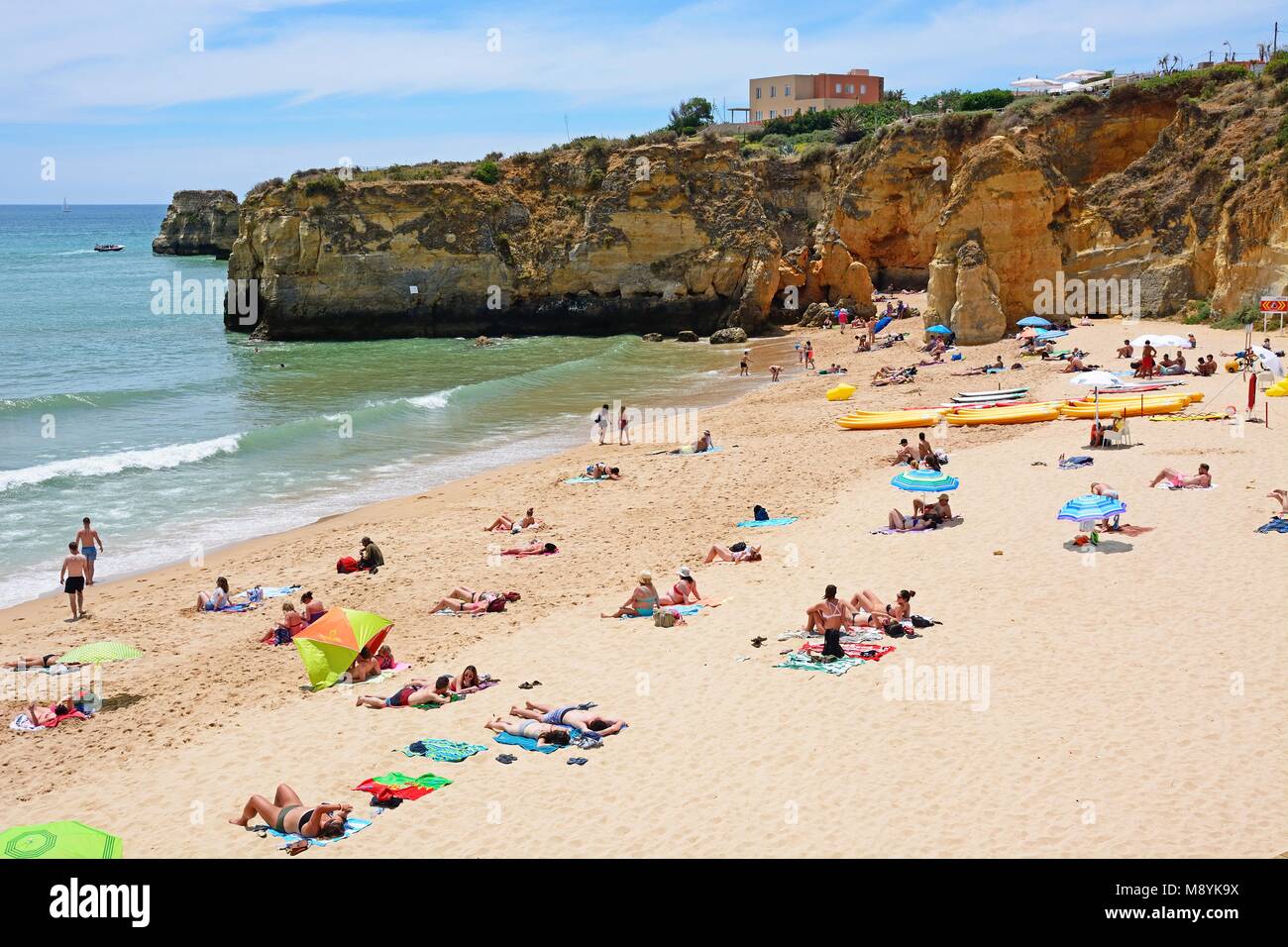 Tourists relaxing on Praia da Batata beach, Lagos, Algarve, Portugal