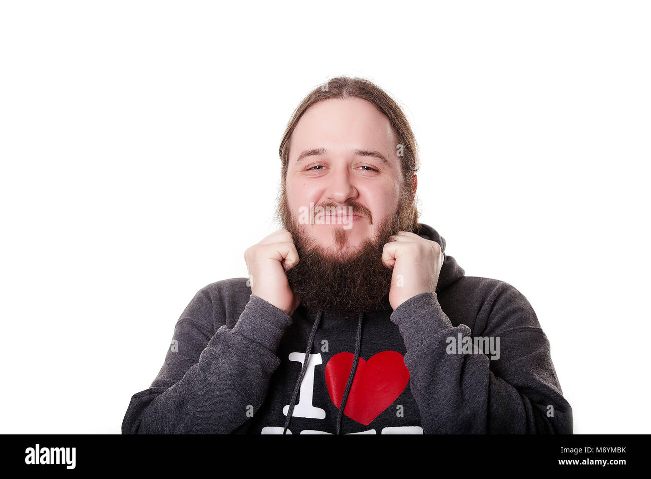 view of one handsome senior stylish man with black hair and long lush beard in black hoodie standing on white backround horisontal picture. Stock Photo