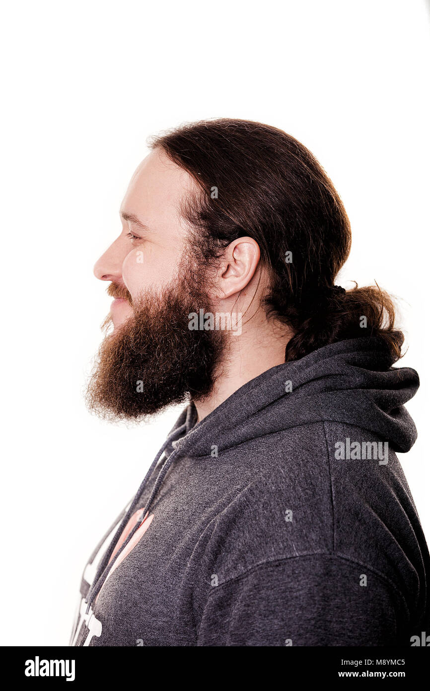 Side View Of Handsome Bearded Man With Long Hair In Casual Clothes