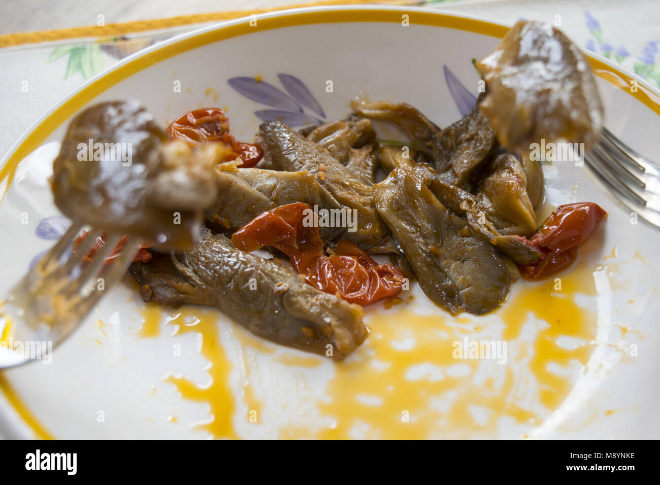 detail of stewed mushrooms stuck in some forks Stock Photo
