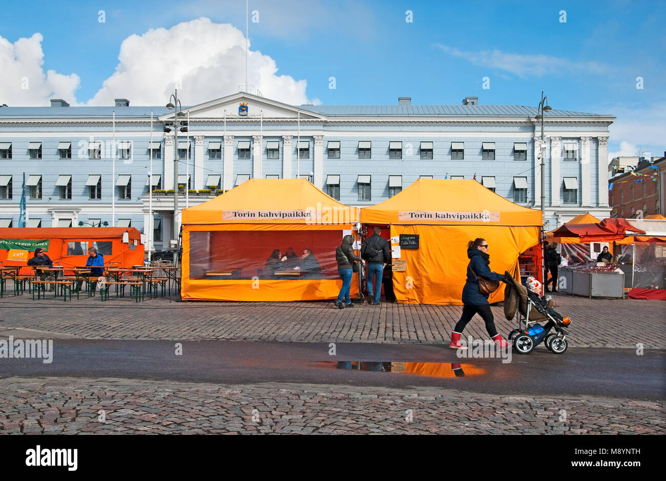 HELSINKI, FINLAND - APRIL 23, 2016: People in open air cafe on The Market Square near Gulf of Finland in the center of Helsinki Stock Photo