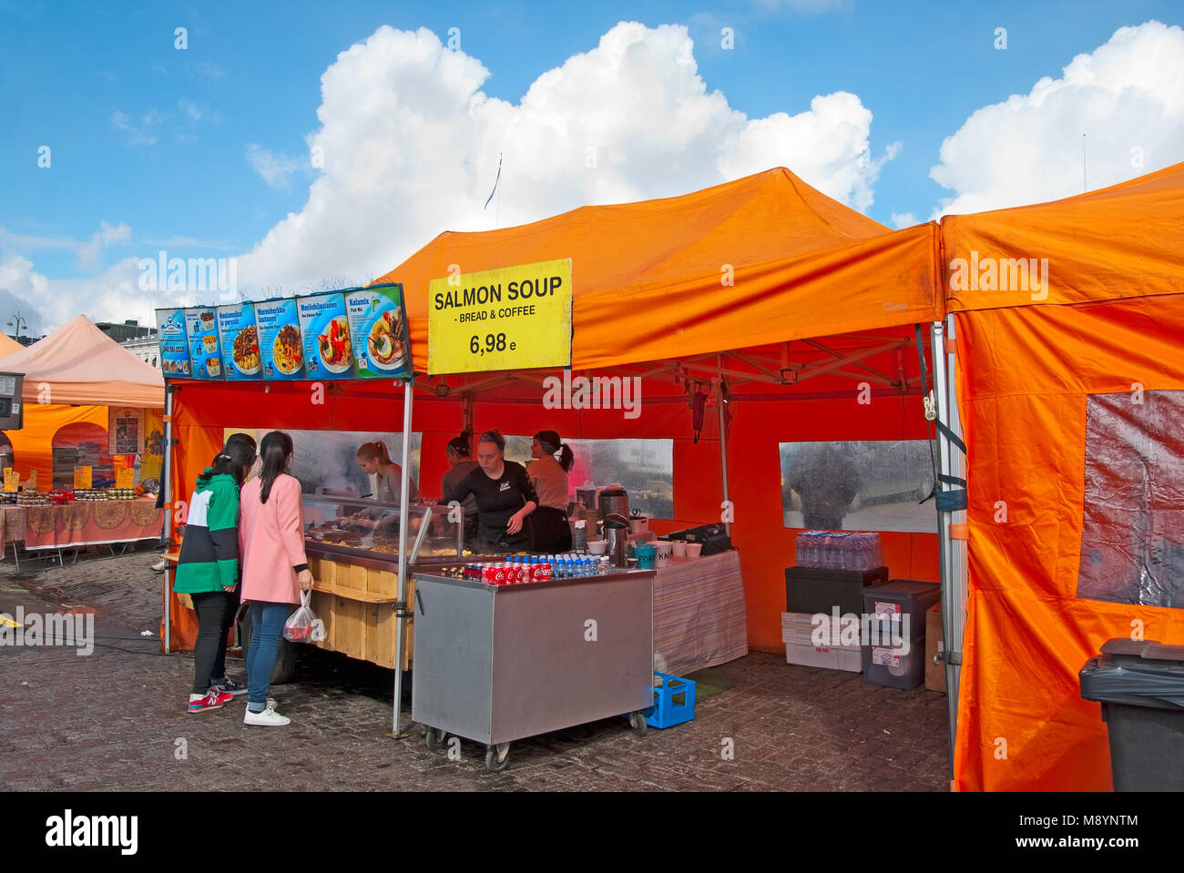 HELSINKI, FINLAND - APRIL 23, 2016: Tourists choose food in open air cafe on The Market Square near Gulf of Finland in the center of Helsinki Stock Photo