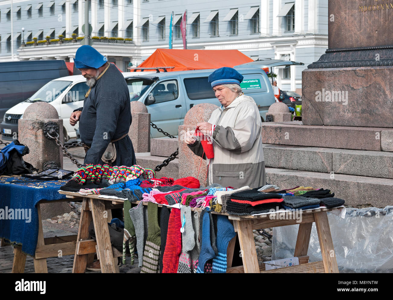 HELSINKI, FINLAND - APRIL 23, 2016: Finnish woman knits and sells colorful woolen goods on The Market Square (Kauppatori) near Gulf of Finland Stock Photo