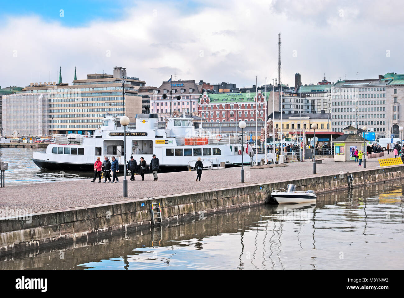 HELSINKI, FINLAND - APRIL 23, 2016: People walk on the quay near The Market Square and pier with ferry to Suomenlinna (Sveaborg) Fortress Stock Photo