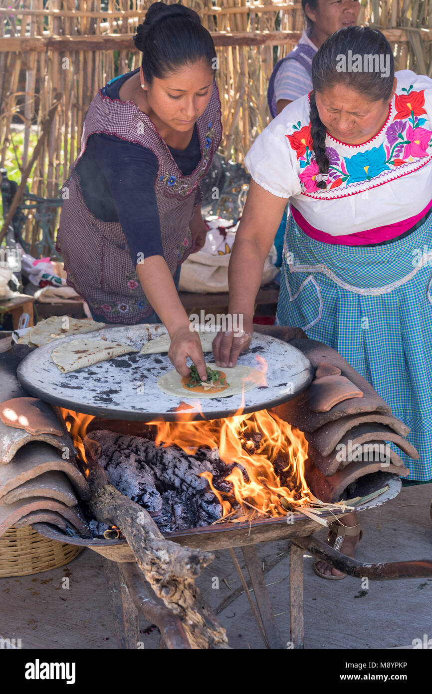 San Juan Teitipac, Oaxaca, Mexico Women making tortillas on a comal during the Linguistic and