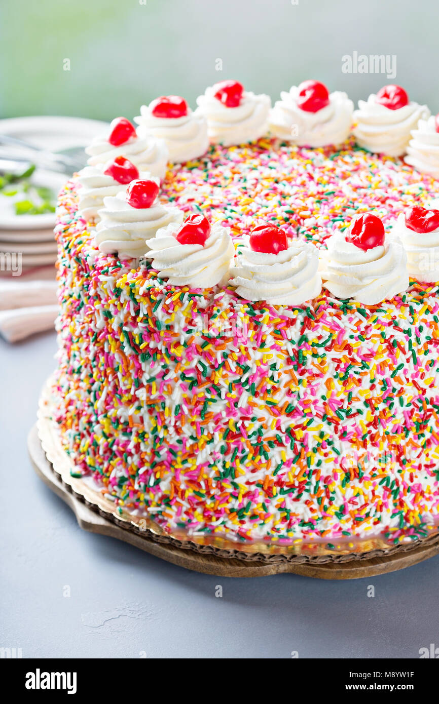 Birthday cake covered in sprinkles Stock Photo Alamy
