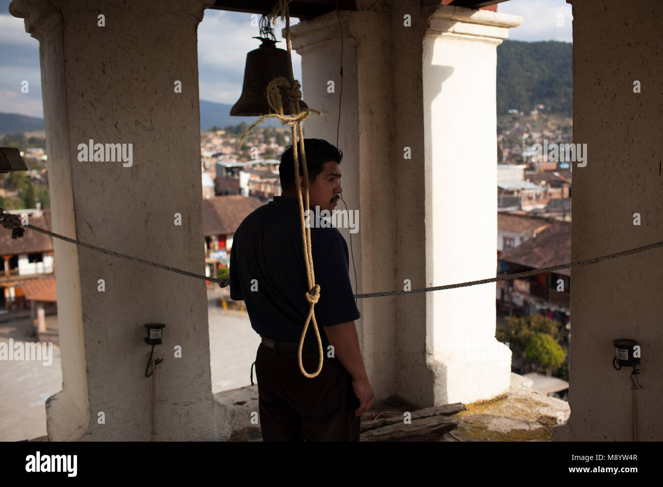 a man rings the bells of the main church in chern michoacn mexico M8YW4R