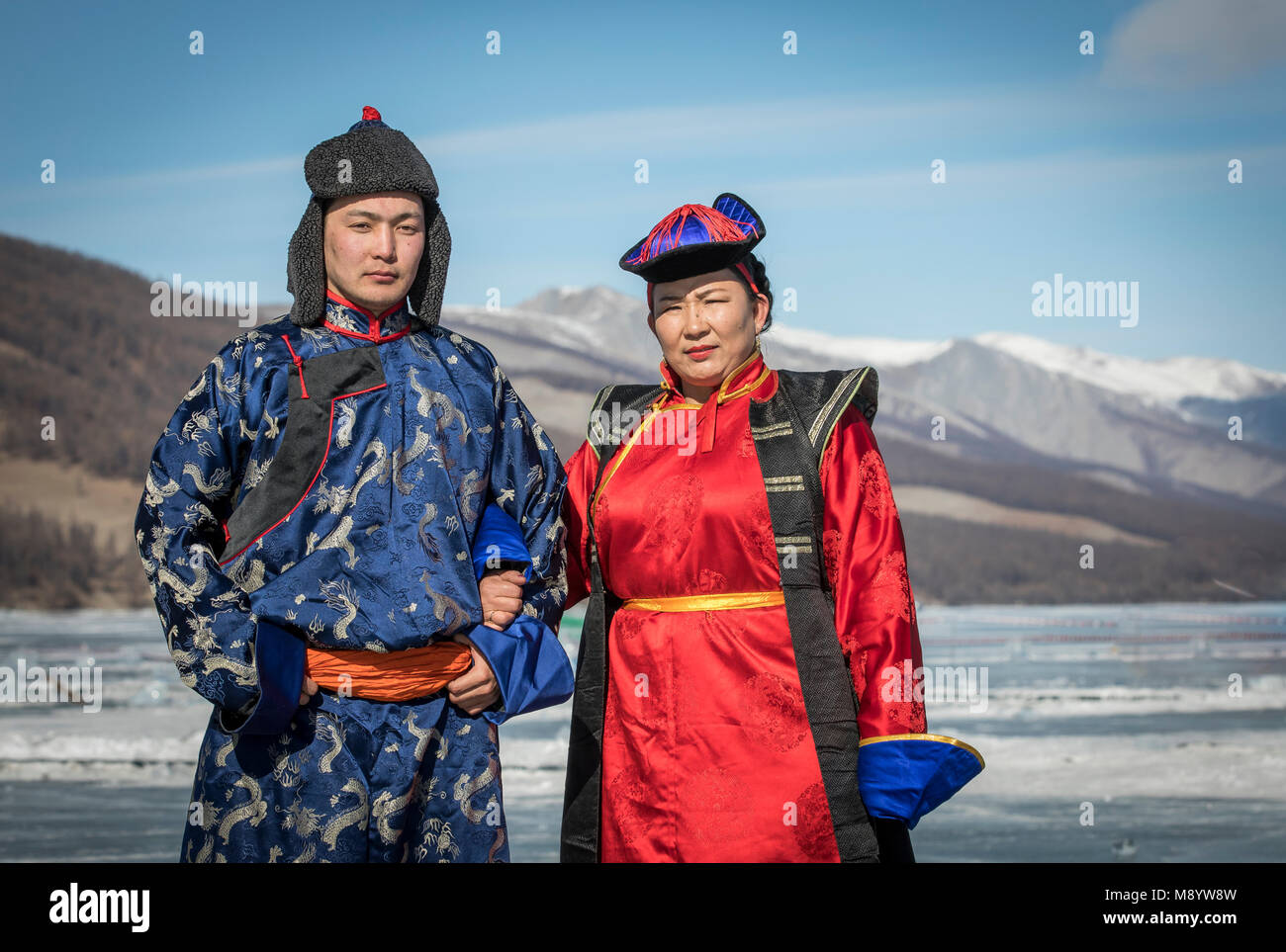 Hatgal, Mongolia, 4th March 2018: mongolian people dressed in traditional clothing on a frozen lake Khuvsgul Stock Photo