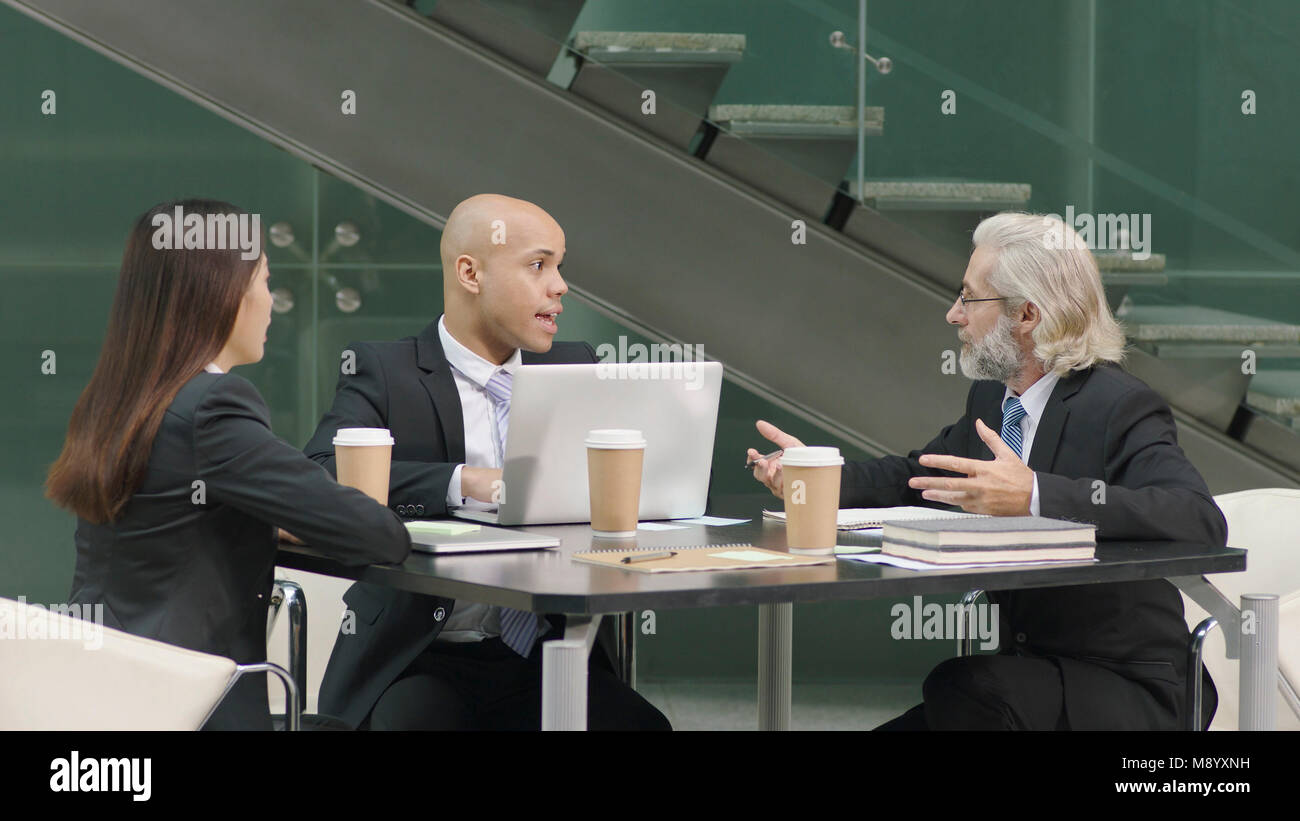 multiethnic corporate executives meeting discussing business in office. Stock Photo