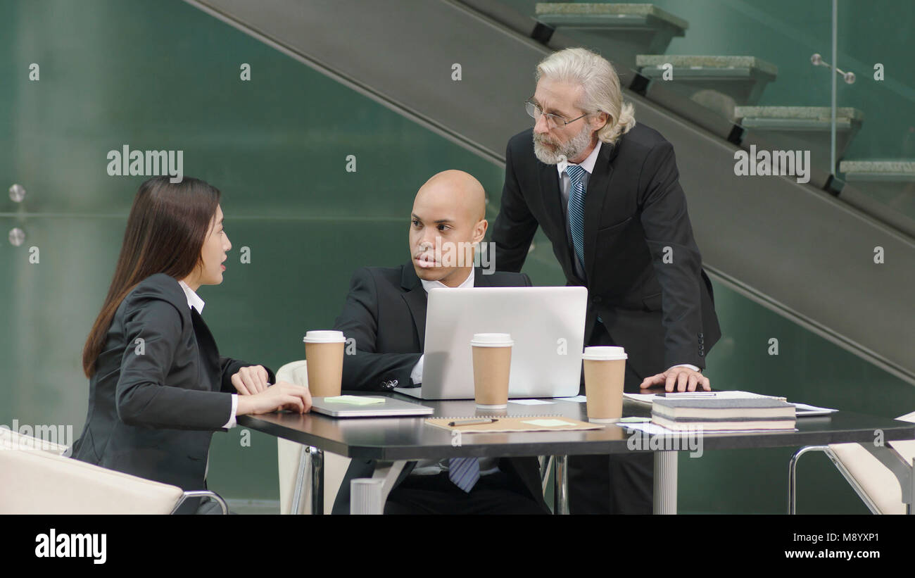 multiethnic corporate executives meeting discussing business in office. Stock Photo
