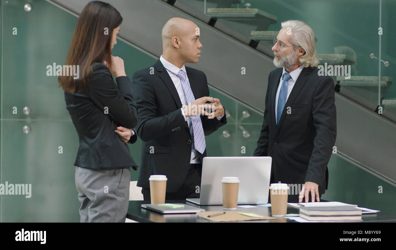 multiethnic corporate executives meeting discussing business in office. Stock Photo