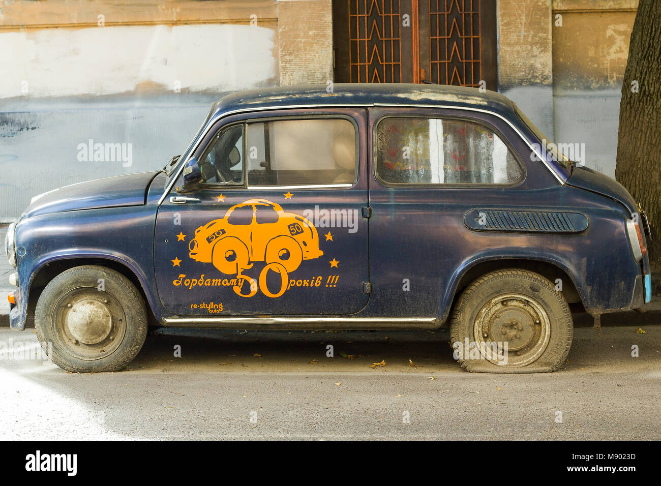 Lviv, Ukraine - August 04, 2017: Old retro Soviet car ZAZ Zaporozhets stands on road.  Vintage blue car on city street with flat tires Stock Photo