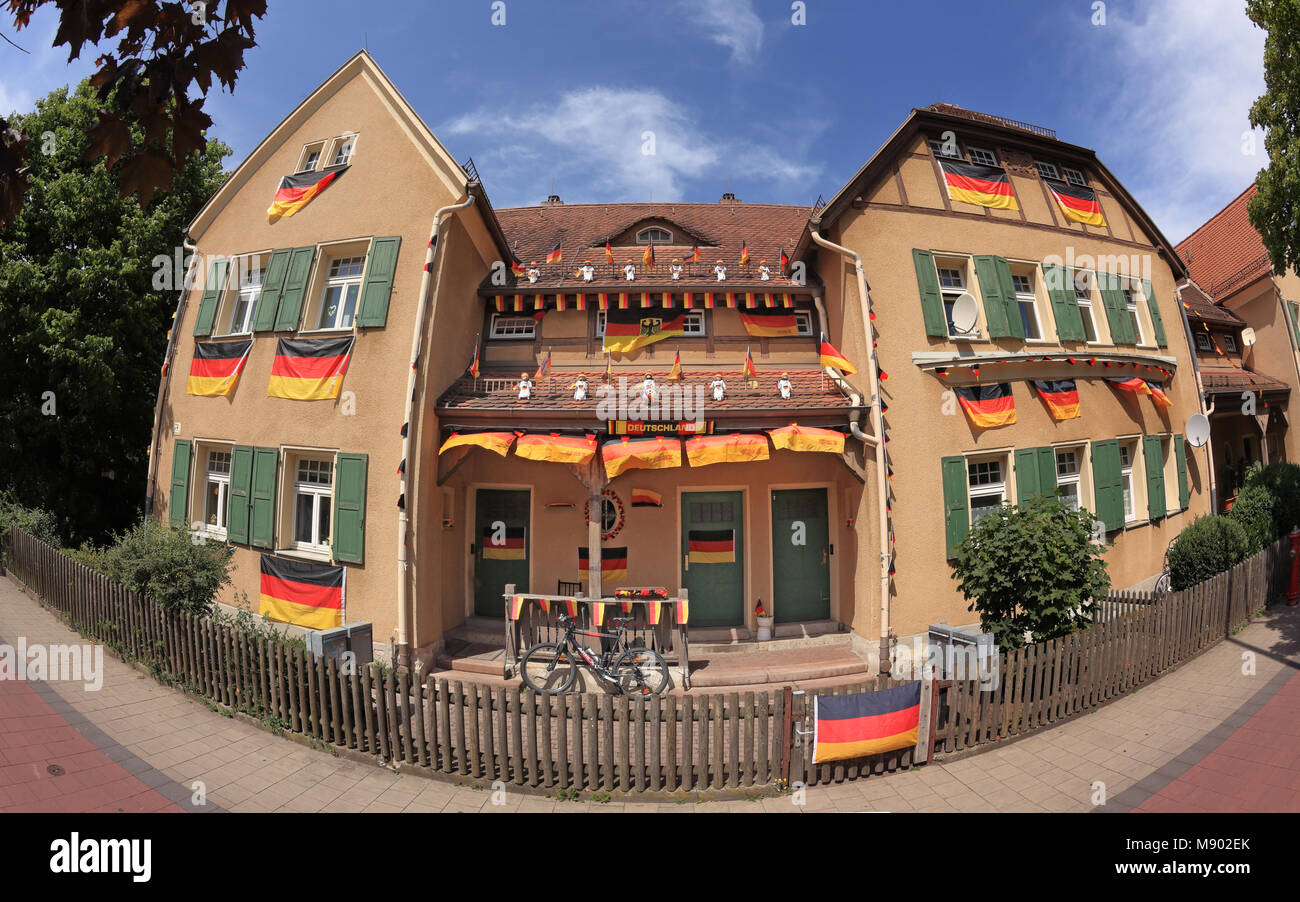 House in Erlangen, Bavaria, Germany, decorated with many German flag for Soccer World Cup 2014, taken with a fisheye lens Stock Photo