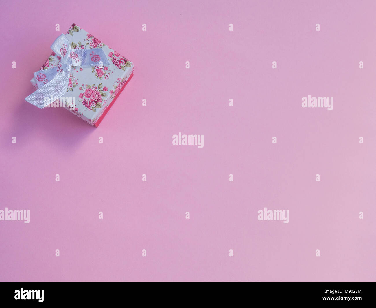 Pink gift box on pink background Stock Photo - Alamy