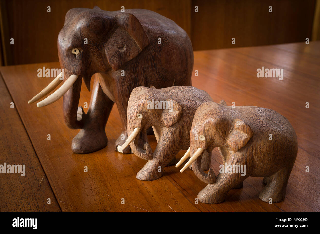 Three wooden elephants collected as souveiers from global travels Stock Photo