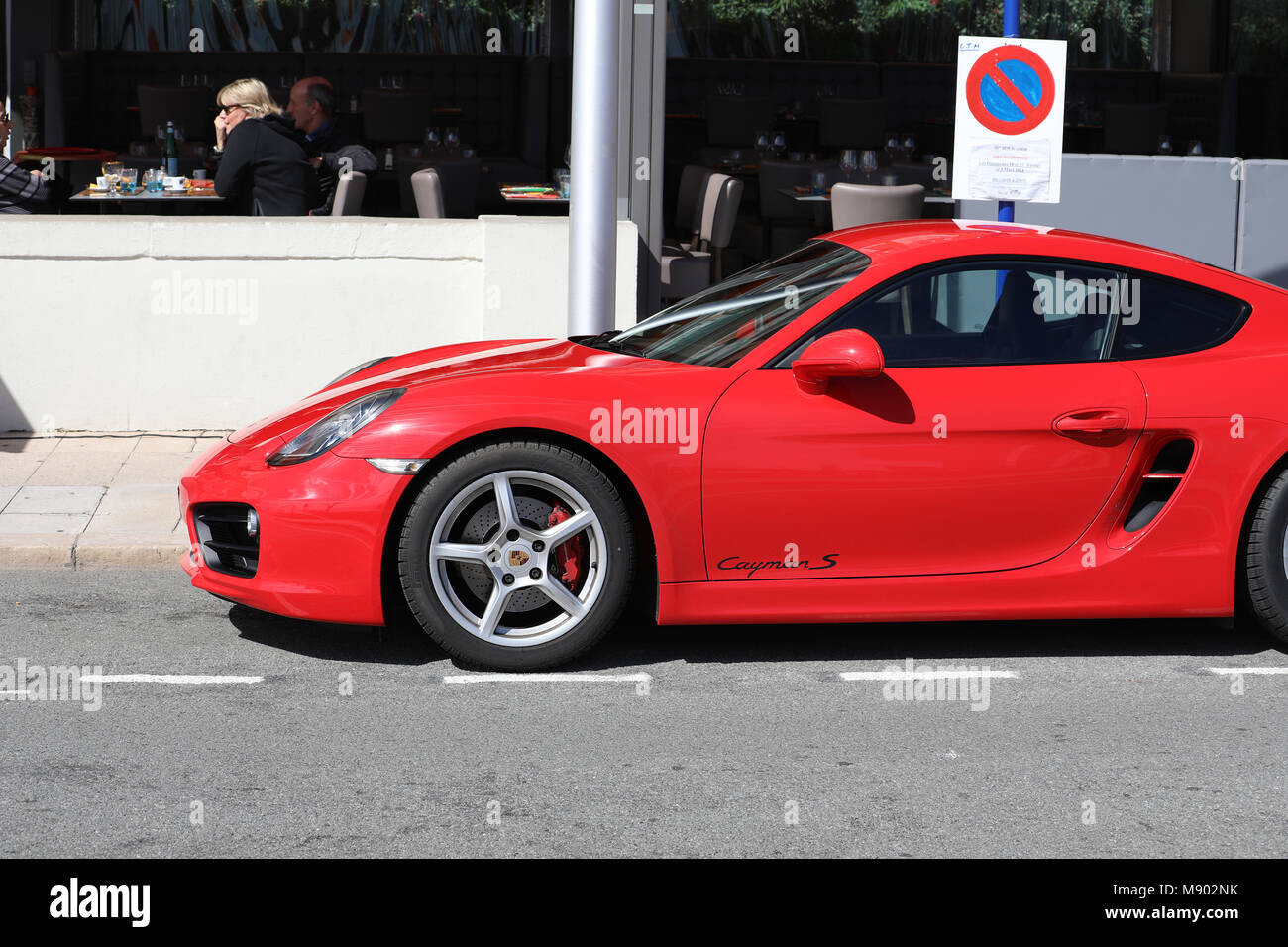 Menton, France - March 19, 2018: Luxury Red Porsche 718 Cayman S Badly Parked Car In The Street Of Menton On The French Riviera Stock Photo