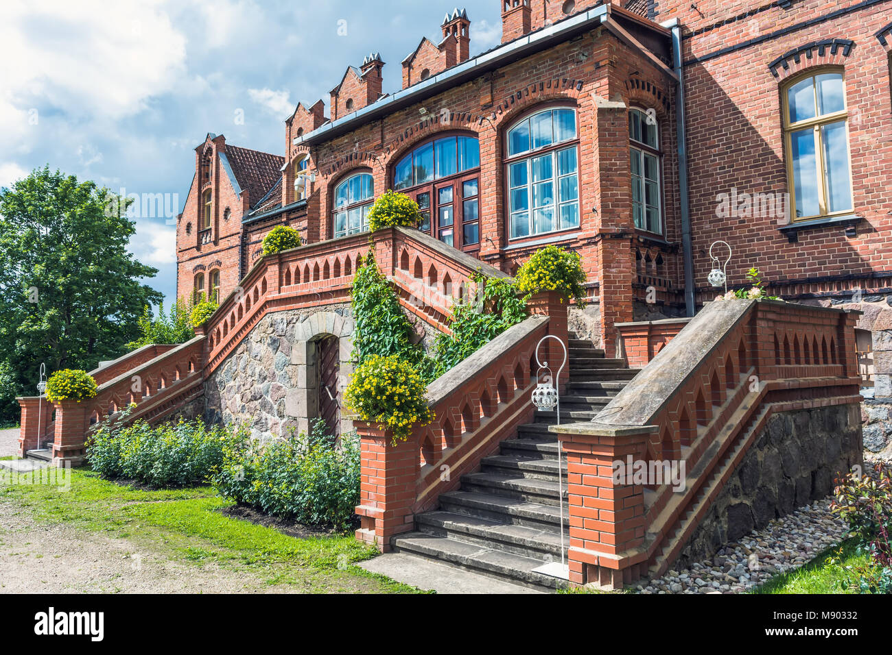 Jaunmokas manor porch. This Neo-Gothic palace was designed by architect Wilhelm Bockslaff and built in 1901. Stock Photo