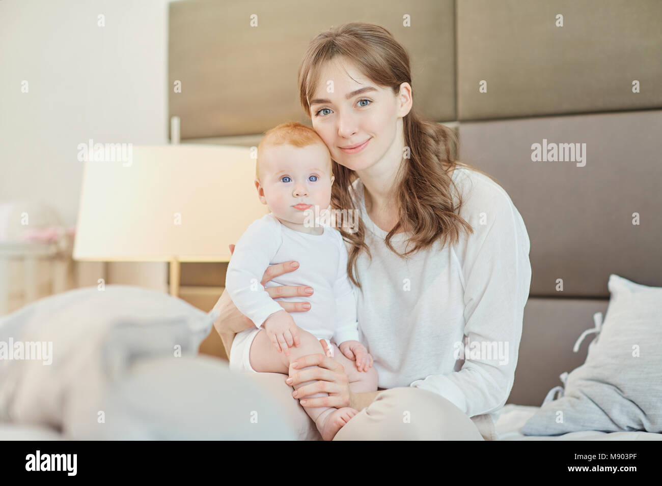 Portrait Mother plays with children on the bed.  Stock Photo