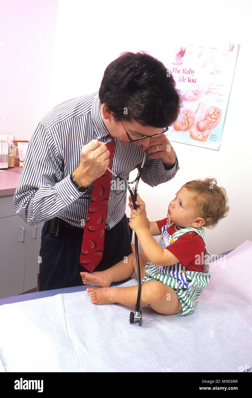 A pediatrician and his young patient Stock Photo