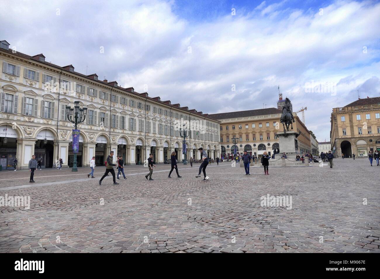 Group of teens students playing soccer in aulic San Carlo square during a break of cultural school trip Turin Italy March 12 2018 Stock Photo