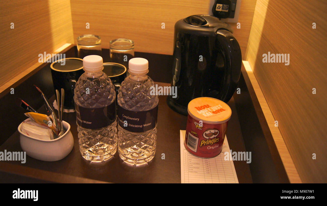 Refrigerator fridge mini size under the table counter with wooden desk  beside it in hotel delux room Stock Photo - Alamy