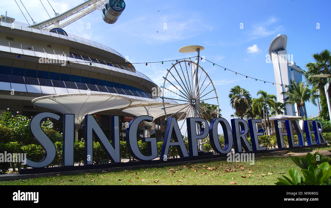 SINGAPORE - APR 2nd 2015: Day view of the Singapore Flyer and the sign. At a height of 165m, Singapore Flyer is the worlds largest giant observation ferries wheel Stock Photo