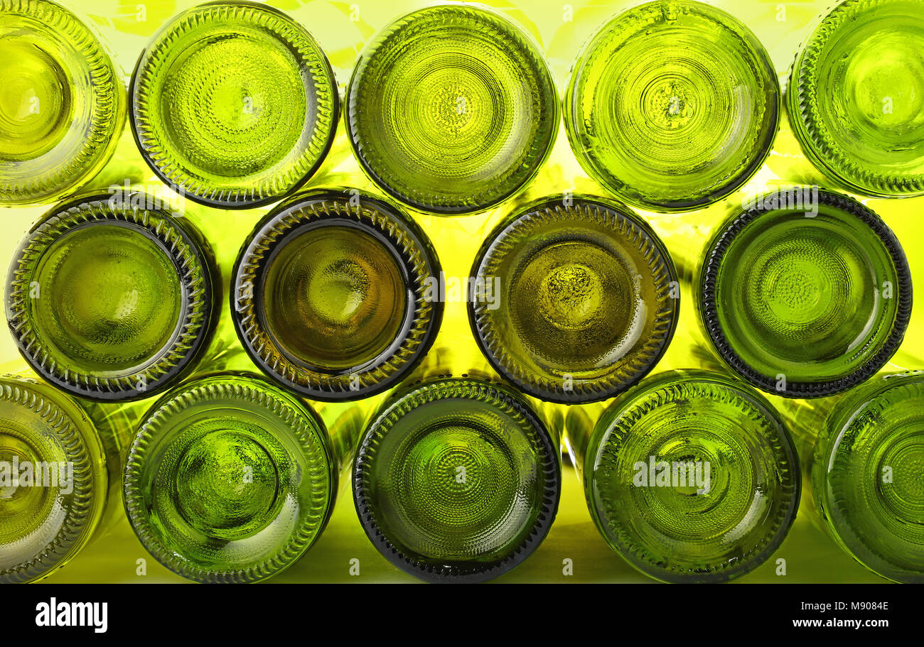 Close up stack of many empty washed green glass wine bottles bottom side, low angle view Stock Photo