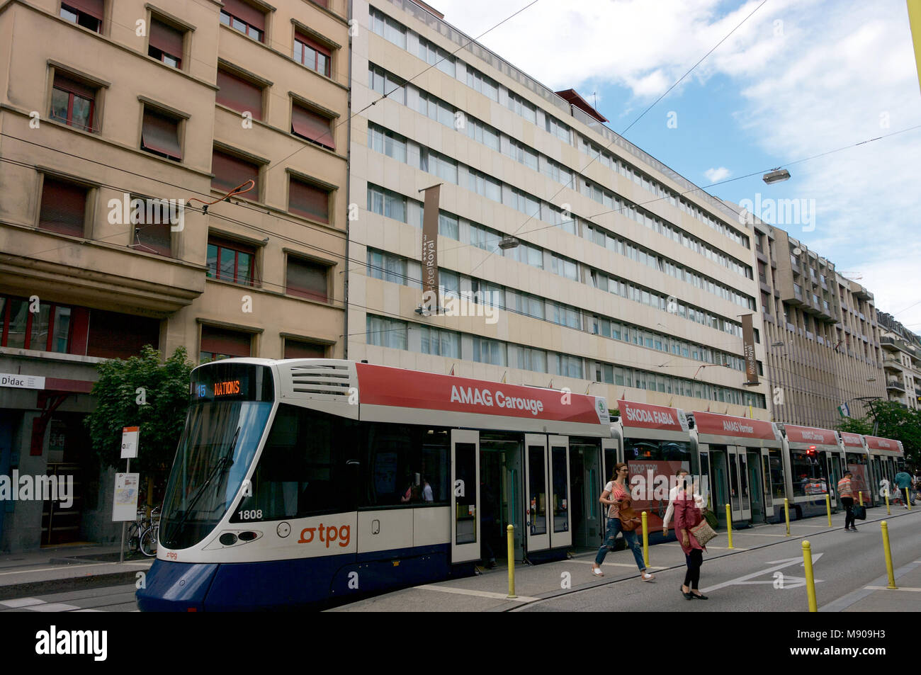 Hotel Royal Geneva Switzerland and city transit electric tram Stock Photo